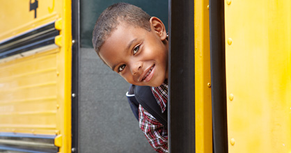 Boy looking back after boarding school bus