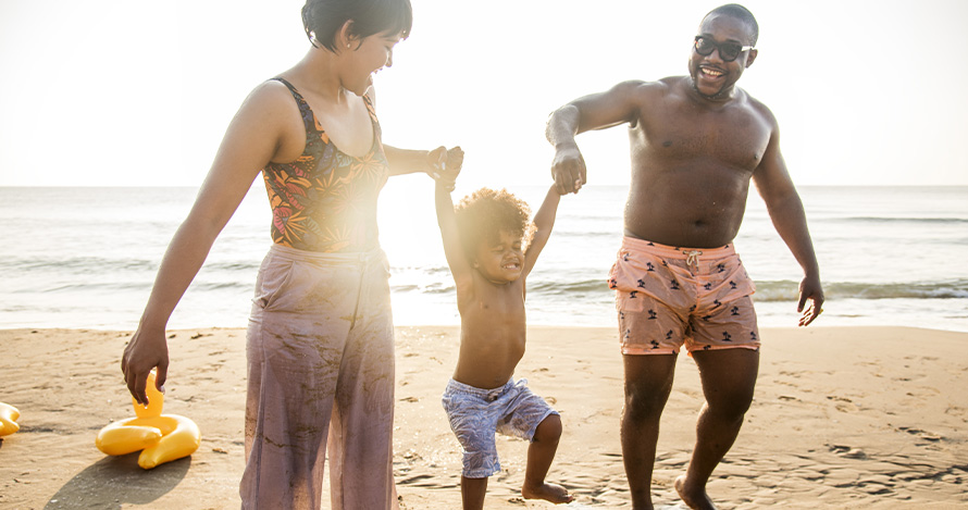 Una familia afroamericana disfruta del tiempo en la playa.