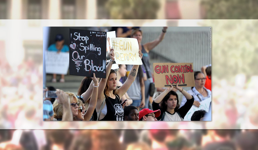 Teens holding signs at gun control rally