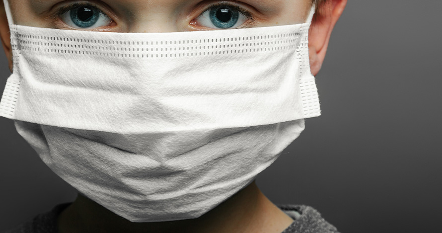 Concerned boy uses a mask during Coronavirus pandemic. 