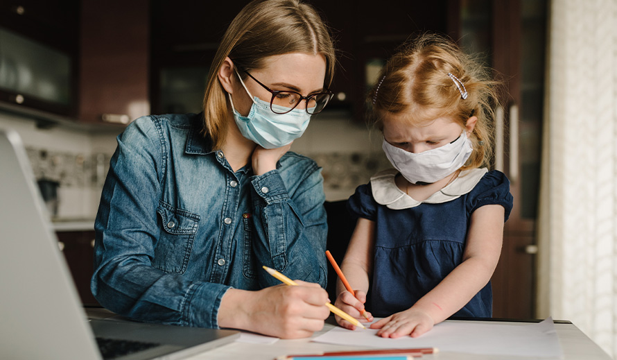 A mother homeschools her daughter during coronavirus pandemic.
