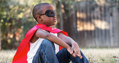 Boy with super hero mask and cape