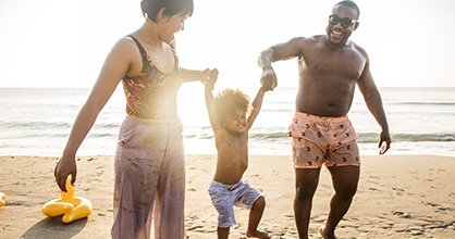 An African American family enjoys time at the beach. 