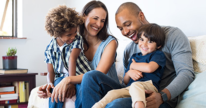  Una familia de raza mixta con hijos adoptados se divierte en casa.