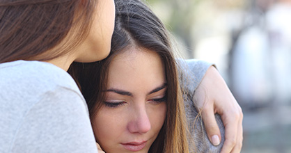 Distraught teen girl being consoled